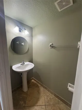 a bathroom with a sink a toilet and mirror