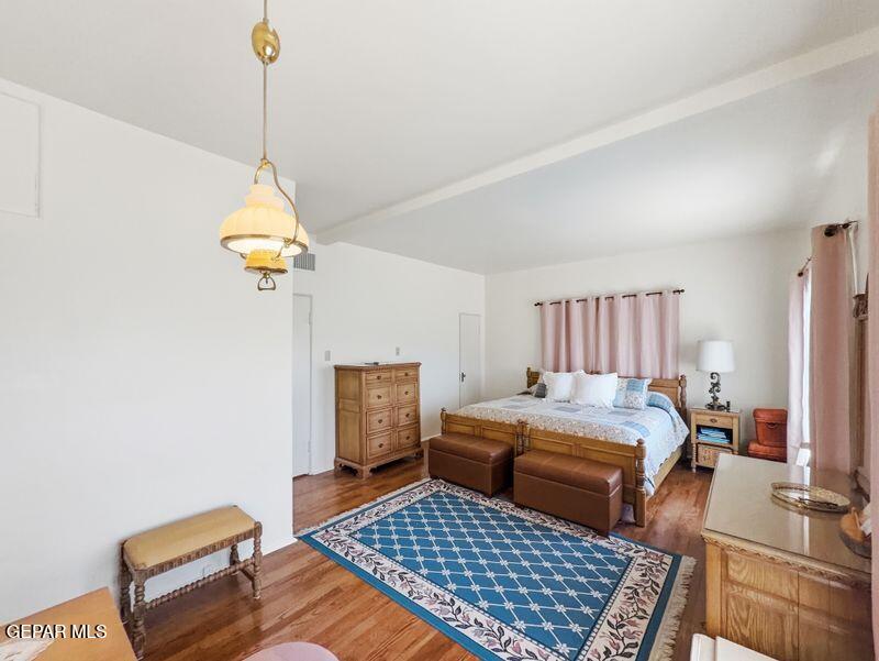 4135 Emory Road El Paso, TX 79922 - Photo 59 of 73 a bedroom with a bed and wooden floor