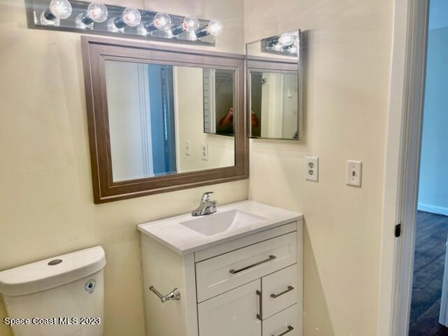 3243 Beach View Way Melbourne Beach, FL 32951 - Photo 11 of 35 a bathroom with a sink a toilet and mirror