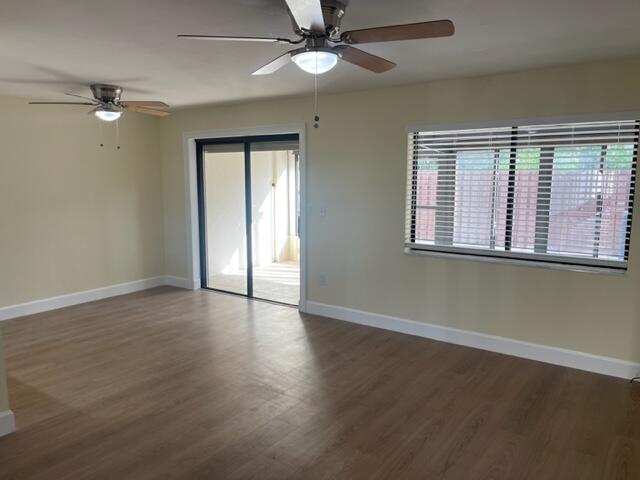 3243 Beach View Way Melbourne Beach, FL 32951 - Photo 2 of 35 an empty room with wooden floor fan and windows