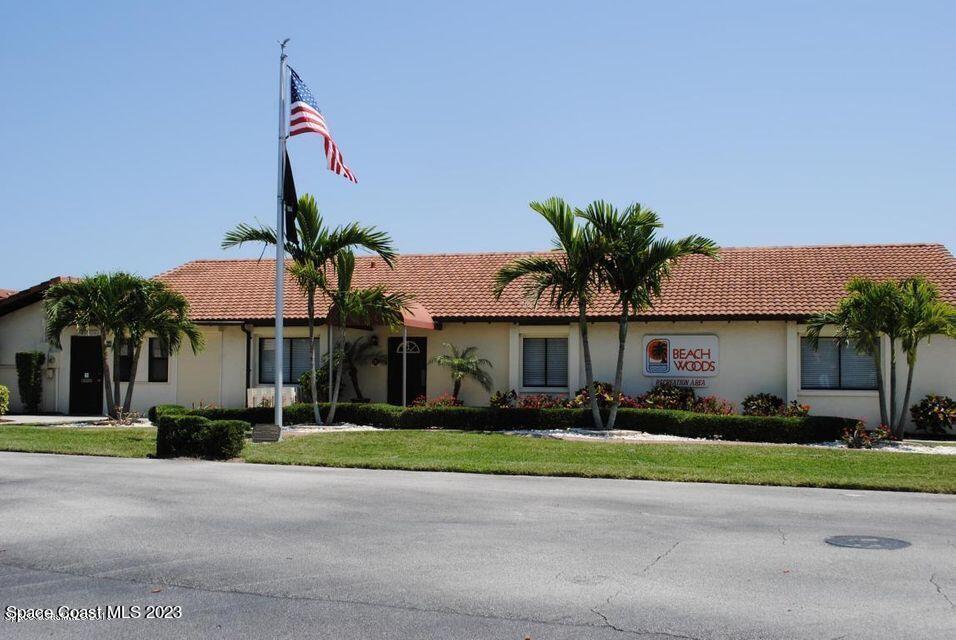 3243 Beach View Way Melbourne Beach, FL 32951 - Photo 27 of 35 a front view of a house with a garden and palm tree