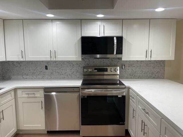 3243 Beach View Way Melbourne Beach, FL 32951 - Photo 7 of 35 a kitchen with a stove and a microwave