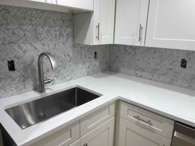 3243 Beach View Way Melbourne Beach, FL 32951 - Photo 9 of 35 a kitchen with a sink and cabinets