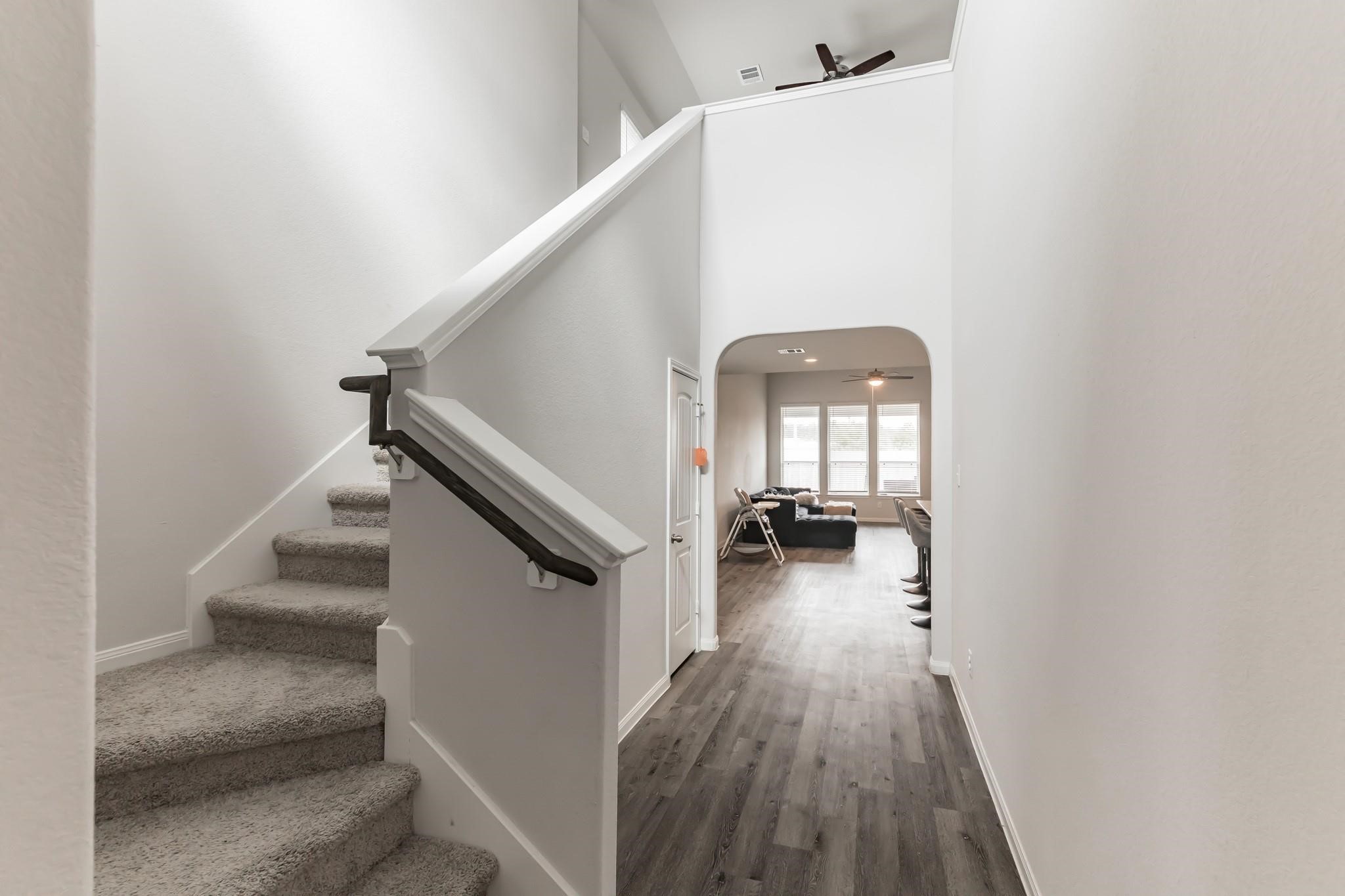 23534 Goodfellow Drive Spring, TX 77373 - Photo 2 of 13 a view of a hallway to a livingroom with wooden floor and stairs