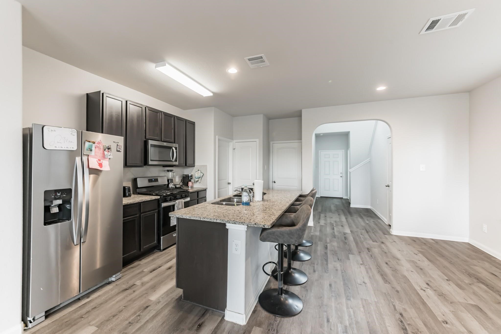 23534 Goodfellow Drive Spring, TX 77373 - Photo 3 of 13 a kitchen with stainless steel appliances a sink cabinets and wooden floor