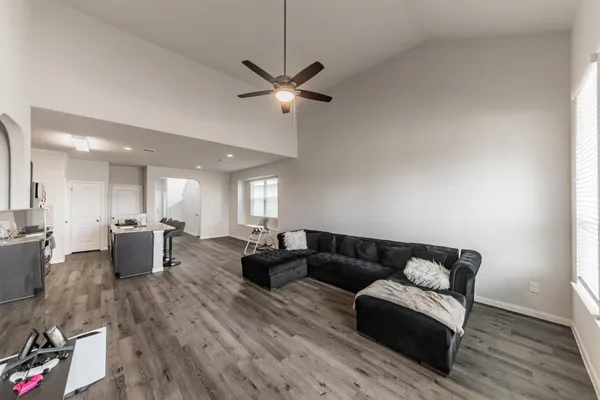 a living room with furniture and a wooden floor