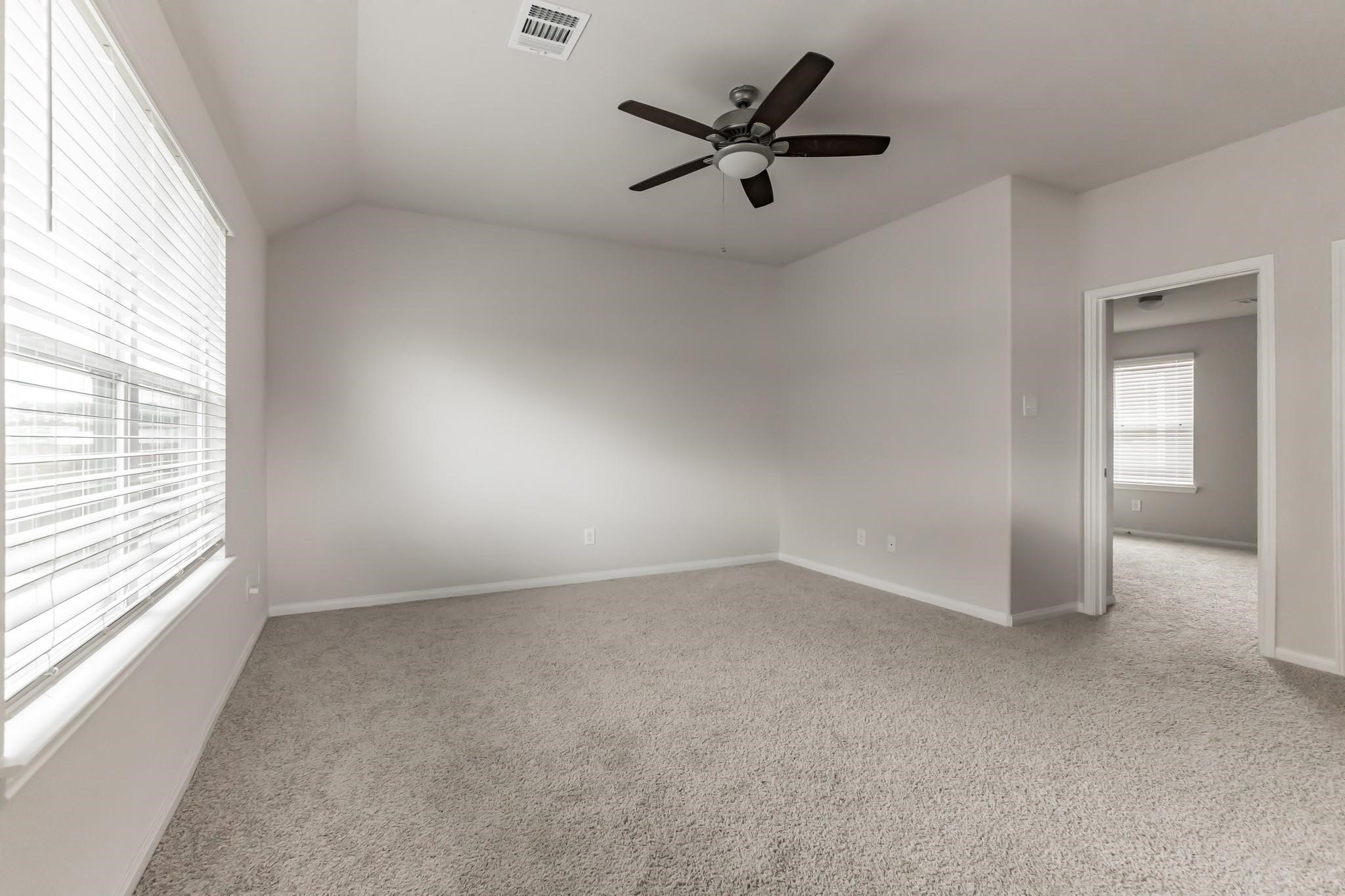 23534 Goodfellow Drive Spring, TX 77373 - Photo 9 of 13 an empty room with a window and a fan
