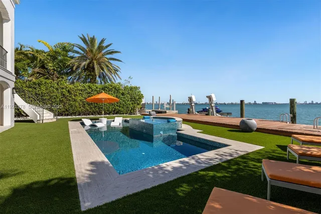 a view of a house with pool and garden