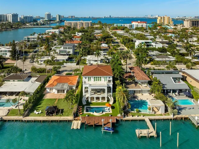 an aerial view of multiple houses with yard