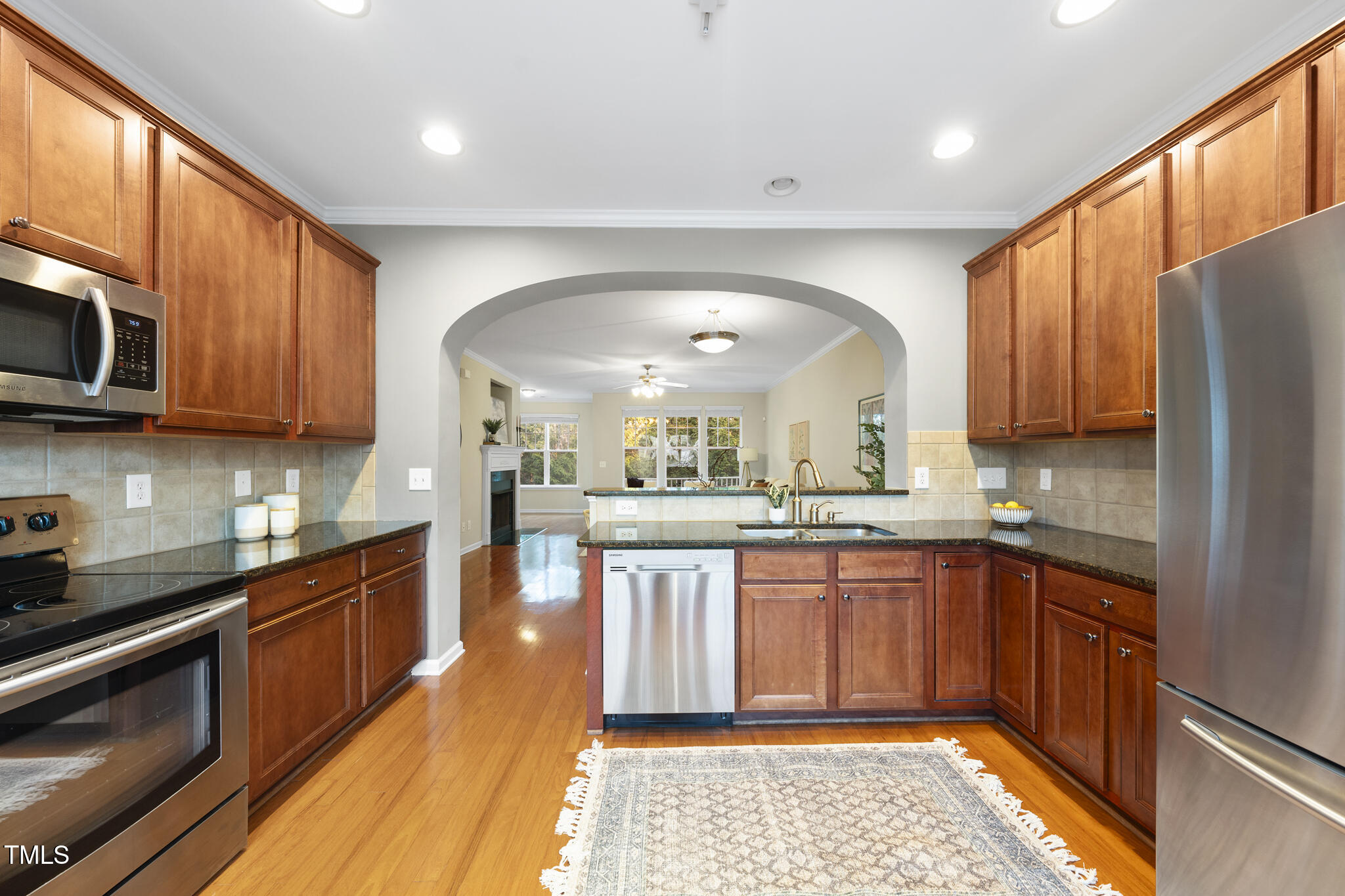5006 Celtic Court Raleigh, NC 27612 - Photo 7 of 28 a large kitchen with stainless steel appliances granite countertop a stove a sink dishwasher and a microwave oven with cabinets
