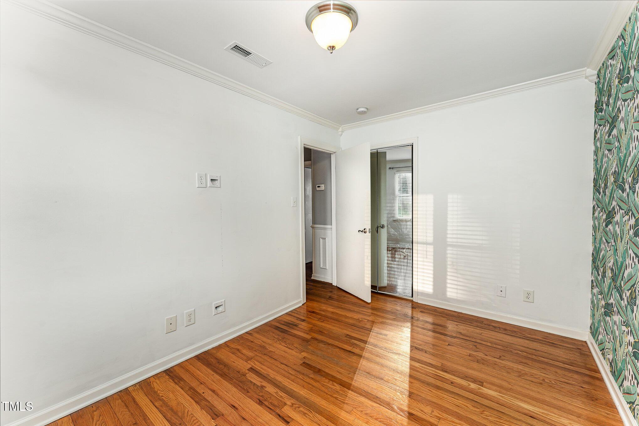 2302 Bernard Street Raleigh, NC 27608 - Photo 11 of 16 a view of an empty room with wooden floor