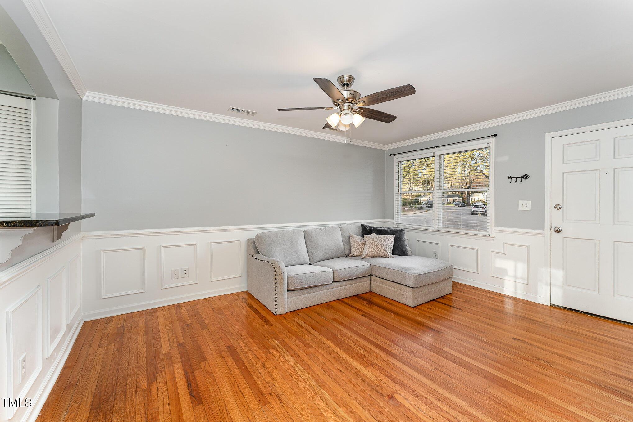 2302 Bernard Street Raleigh, NC 27608 - Photo 3 of 16 a living room with furniture and a wooden floor