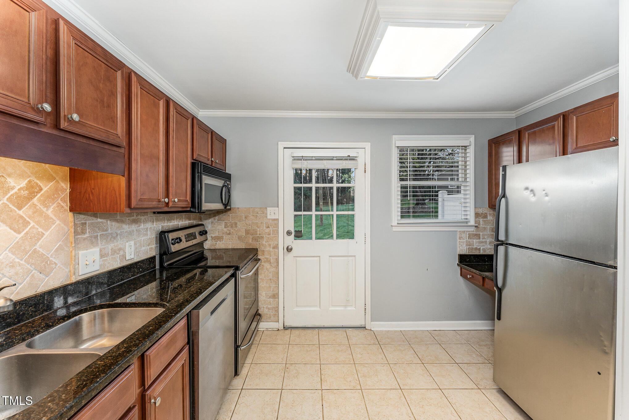 2302 Bernard Street Raleigh, NC 27608 - Photo 5 of 16 a kitchen with granite countertop a refrigerator stove and sink