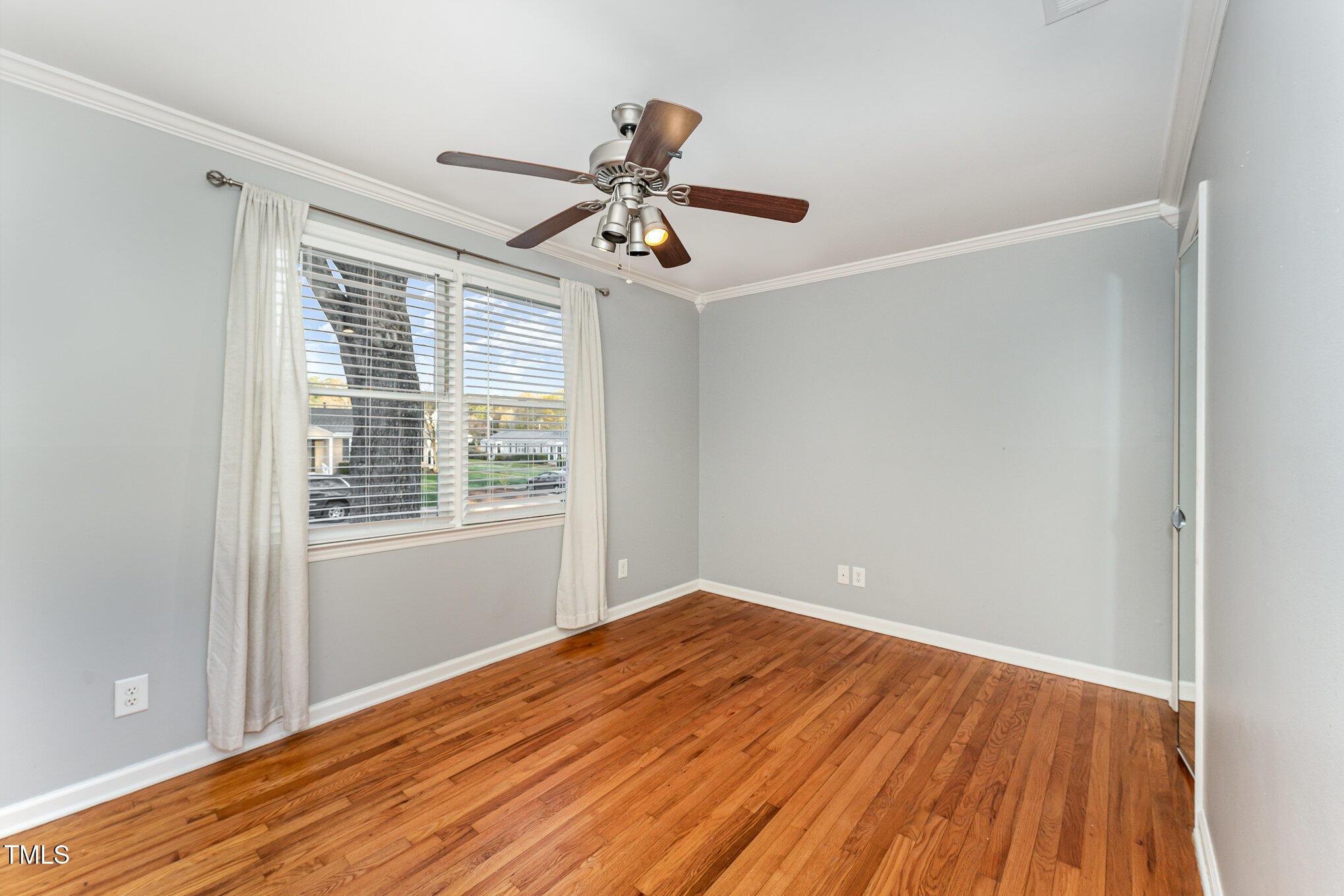 2302 Bernard Street Raleigh, NC 27608 - Photo 7 of 16 a view of empty room with wooden floor and fan