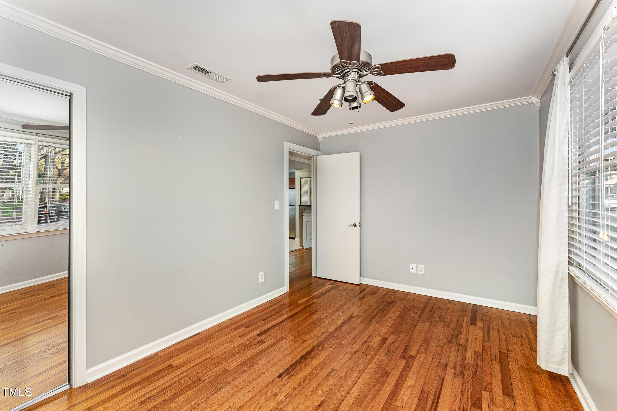 2302 Bernard Street Raleigh, NC 27608 - Photo 8 of 16 a view of room with hardwood floor and ceiling fan