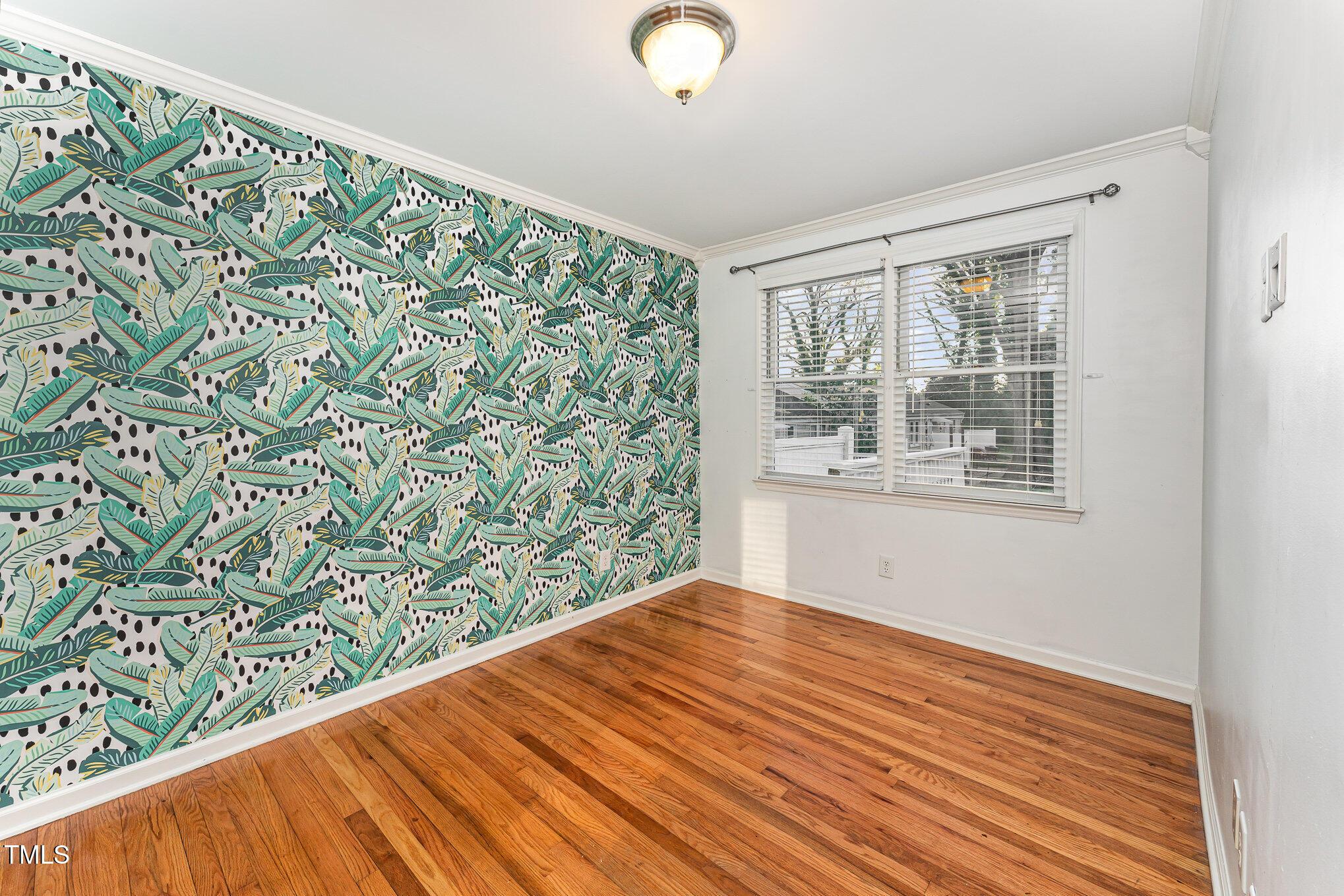 2302 Bernard Street Raleigh, NC 27608 - Photo 10 of 16 a view of an empty room with wooden floor and a window