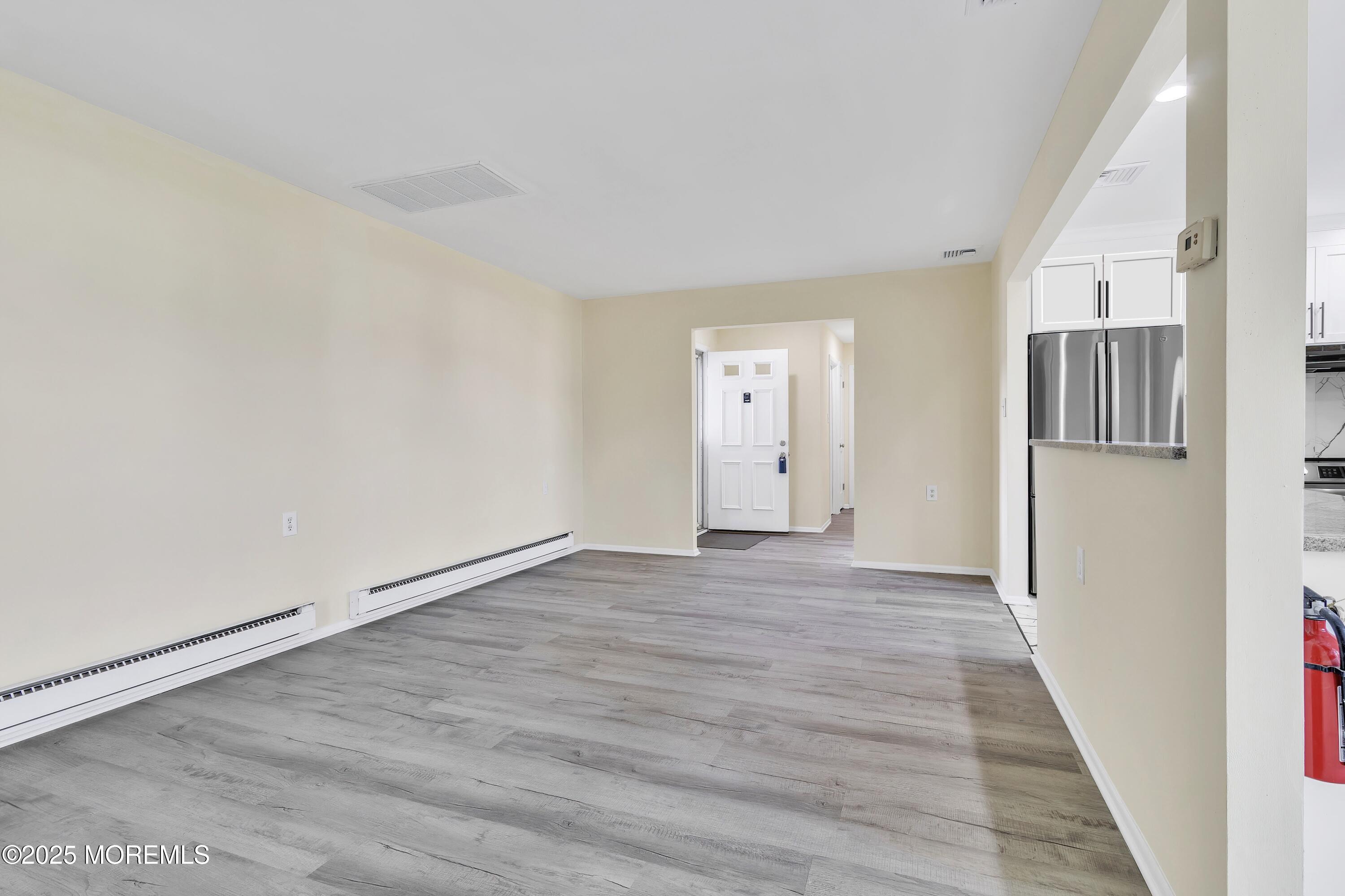 1 Markham Road Brick, NJ 08724 - Photo 14 of 63 a view of an empty room with wooden floor and a window