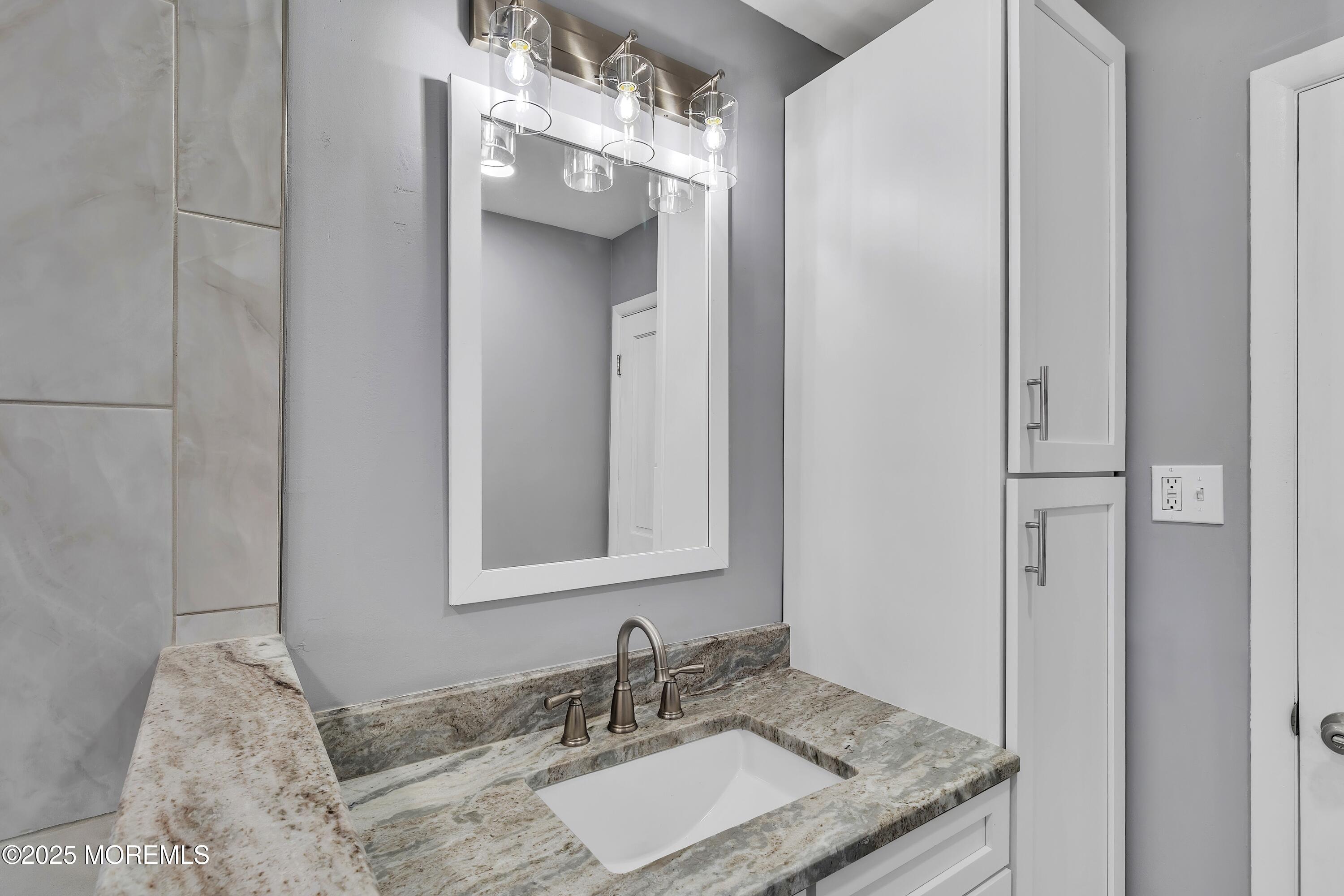 1 Markham Road Brick, NJ 08724 - Photo 27 of 63 a bathroom with a granite countertop sink and a mirror
