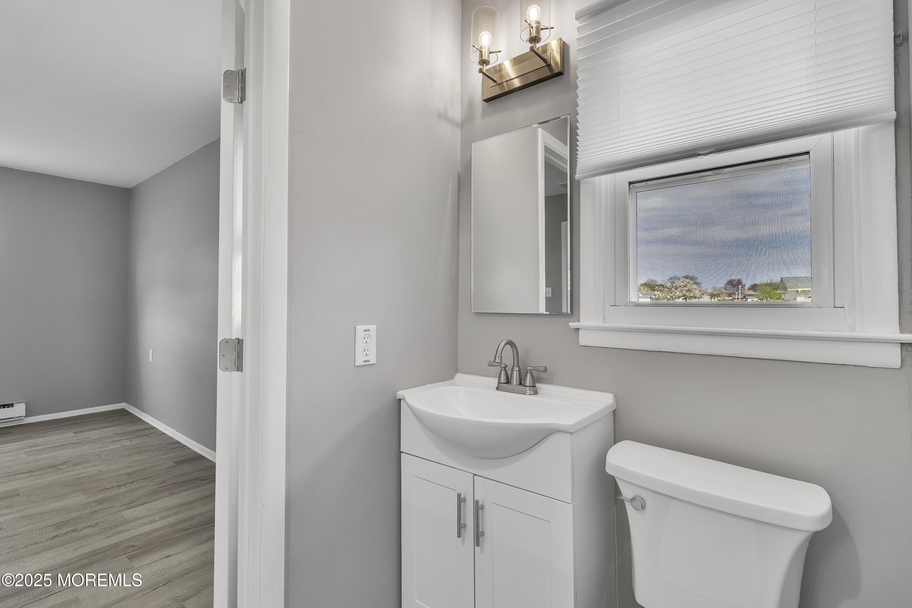 1 Markham Road Brick, NJ 08724 - Photo 29 of 63 a bathroom with a toilet sink and mirror