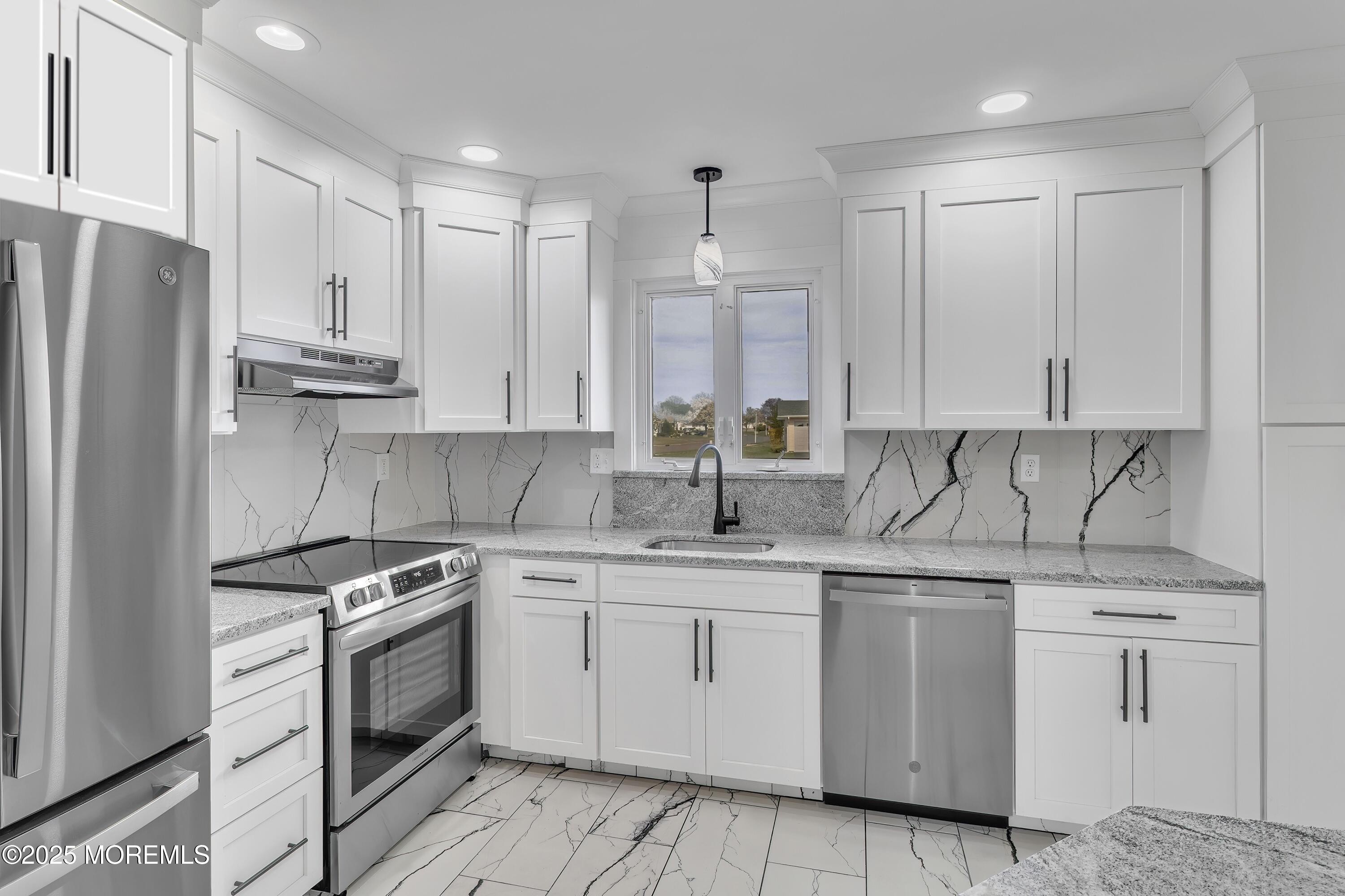 1 Markham Road Brick, NJ 08724 - Photo 3 of 63 a kitchen with white cabinets stainless steel appliances and sink