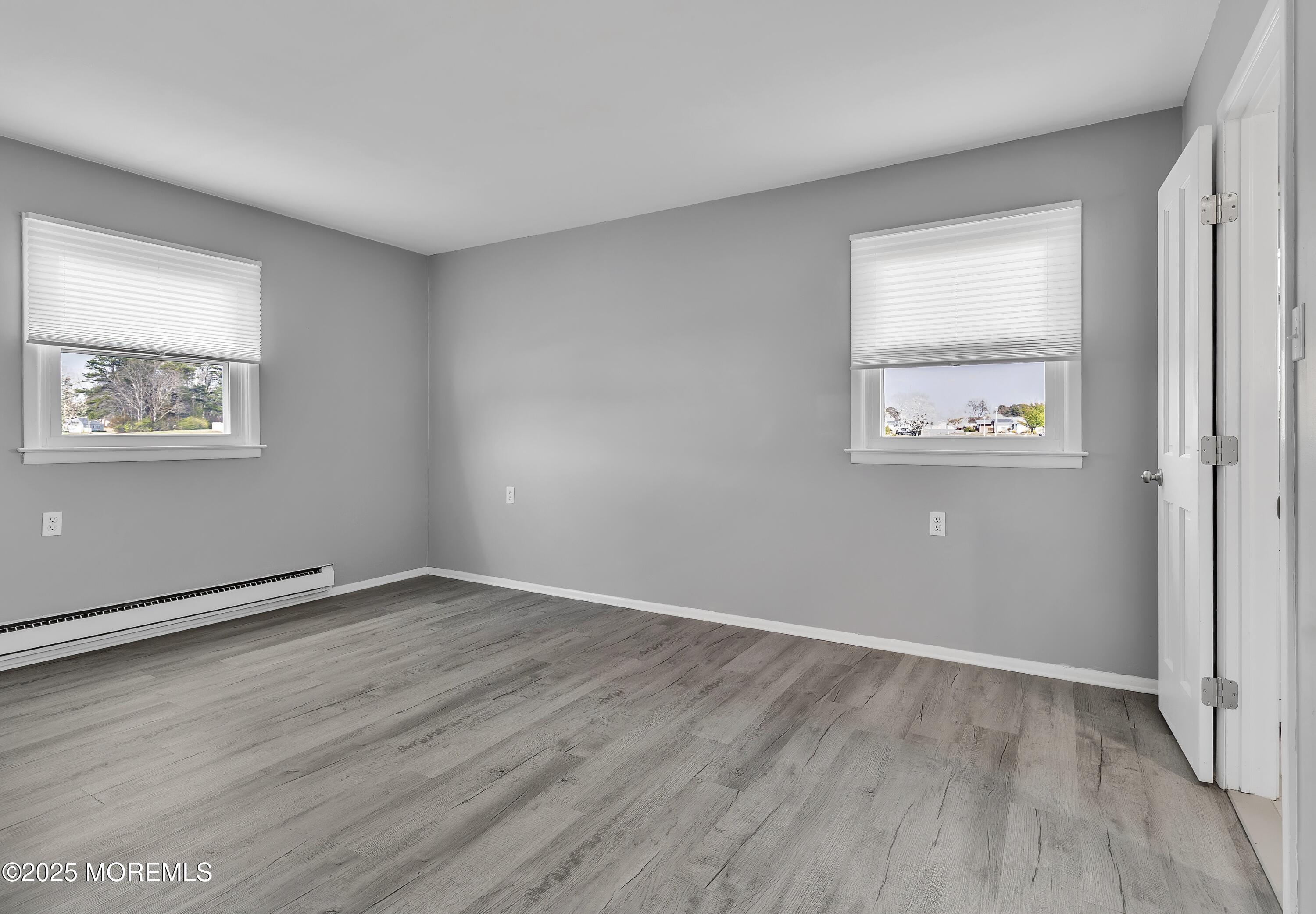 1 Markham Road Brick, NJ 08724 - Photo 32 of 63 an empty room with wooden floor and windows