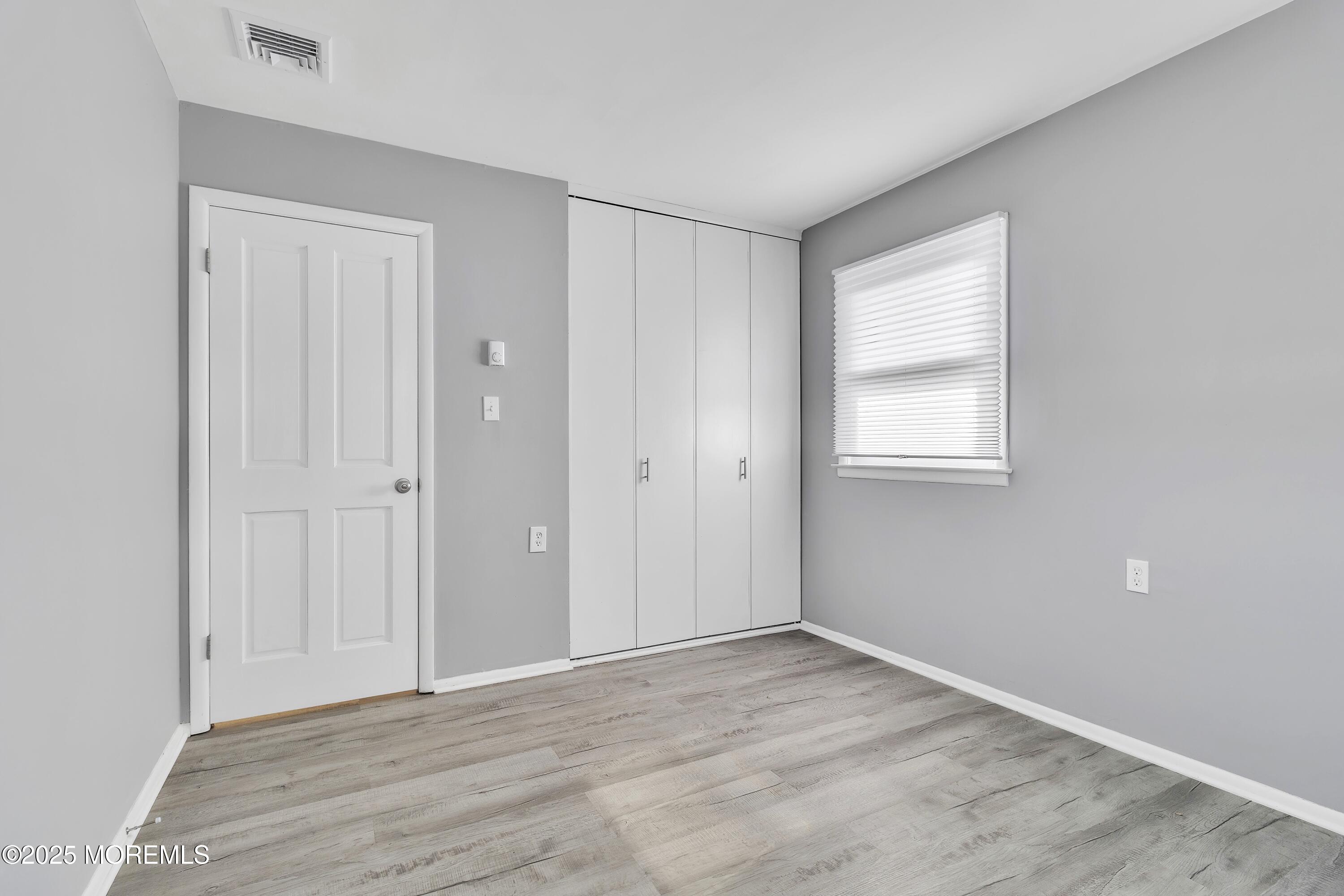 1 Markham Road Brick, NJ 08724 - Photo 38 of 63 a view of an empty room with wooden floor and a window