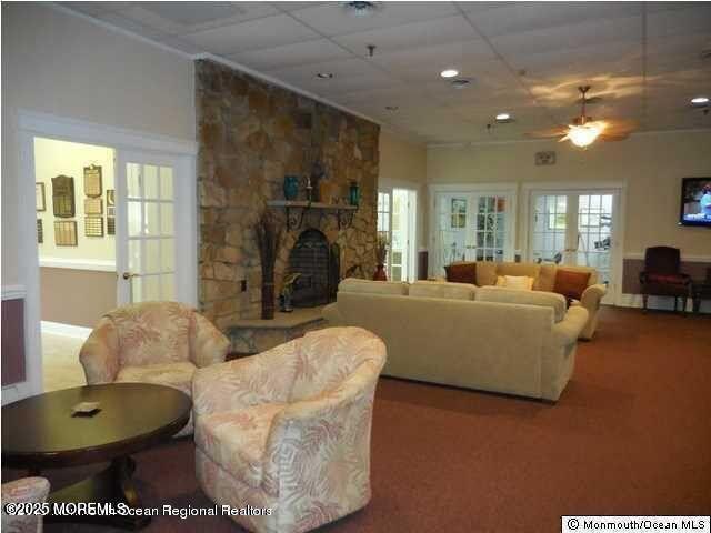 1 Markham Road Brick, NJ 08724 - Photo 56 of 63 a living room with furniture a fireplace and a chandelier