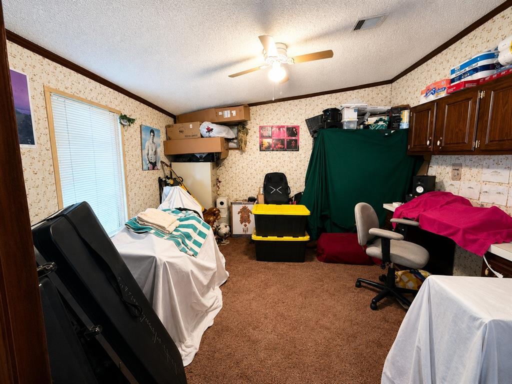 2665 Absher Road St. Cloud, FL 34771 - Photo 20 of 27 a bedroom with bed and a car