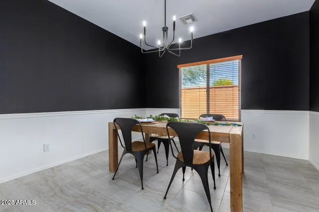 a view of a dining room with furniture and chandelier