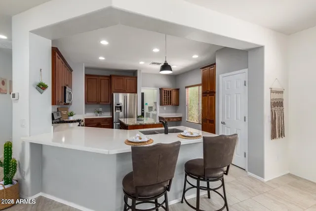 a large kitchen with a table and chairs