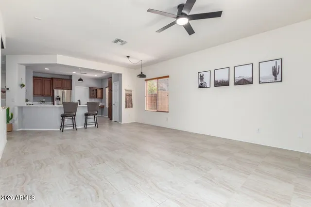 a view of a livingroom with furniture and a ceiling fan