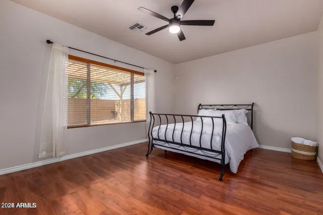 a spacious bedroom with a large bed and a window