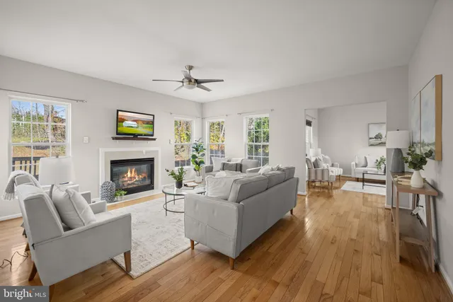 a living room with furniture a fireplace and a large window