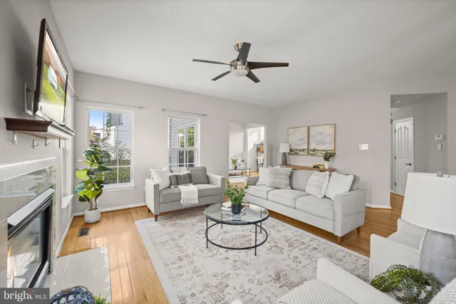a living room with furniture a fireplace and a table