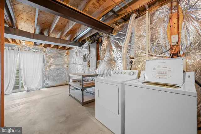 an empty room with closet fan and windows