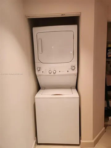 a front view of a house with a yard and palm trees