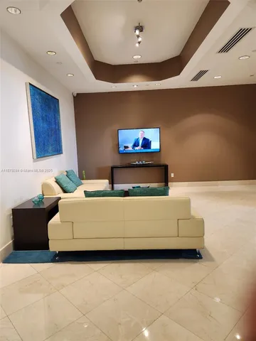 a living room with furniture and flat screen tv