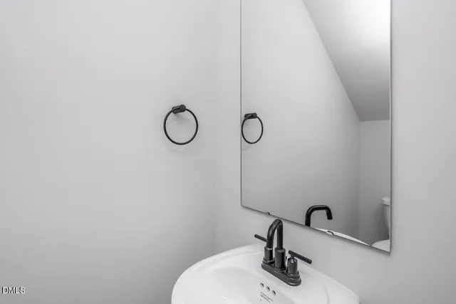 a bathroom with a sink and mirror