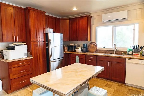 a kitchen with a refrigerator a stove a sink and dishwasher with wooden floor