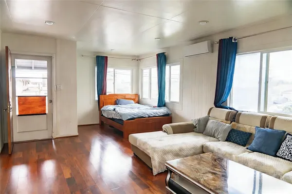 a bedroom with furniture and wooden floor