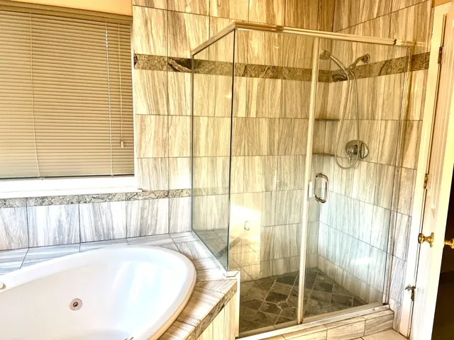 a bathroom with a tub and shower
