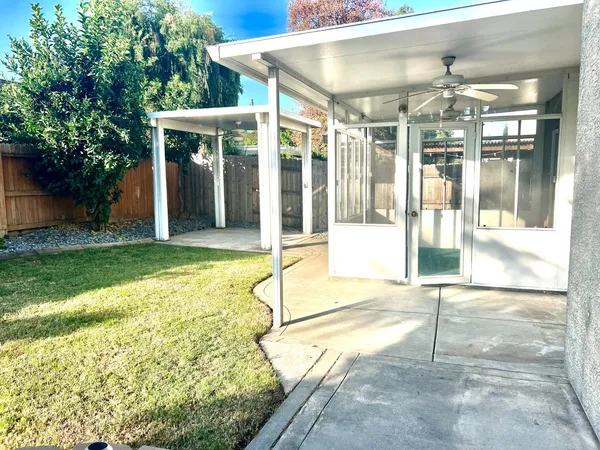 a view of a house with a backyard and balcony