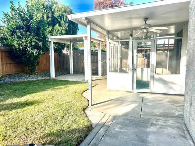 a view of a house with a backyard and balcony