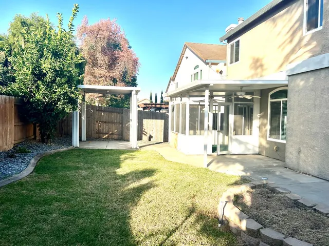 a view of a house with a yard and porch