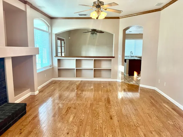 a view of a room with wooden floor and cabinet