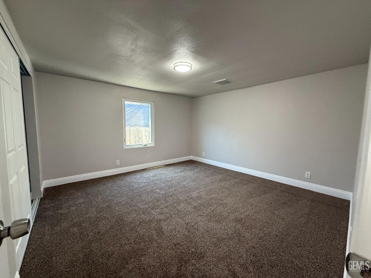 Undisclosed Address Bakersfield, CA 93307 - Photo 13 of 27 an empty room with a window