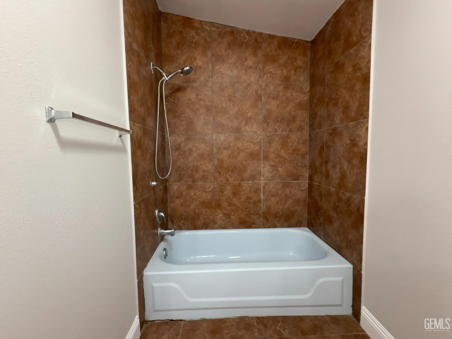 Undisclosed Address Bakersfield, CA 93307 - Photo 18 of 27 a bathroom with a bathtub