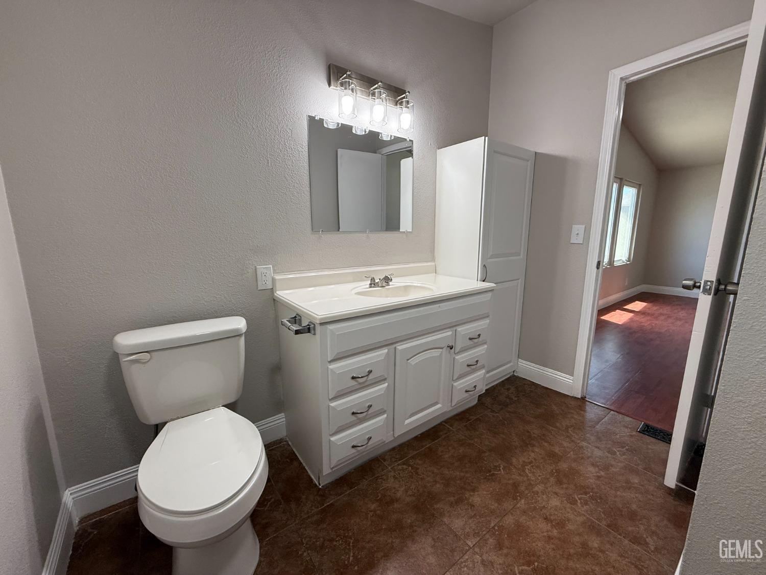 Undisclosed Address Bakersfield, CA 93307 - Photo 19 of 27 a bathroom with a toilet sink and mirror
