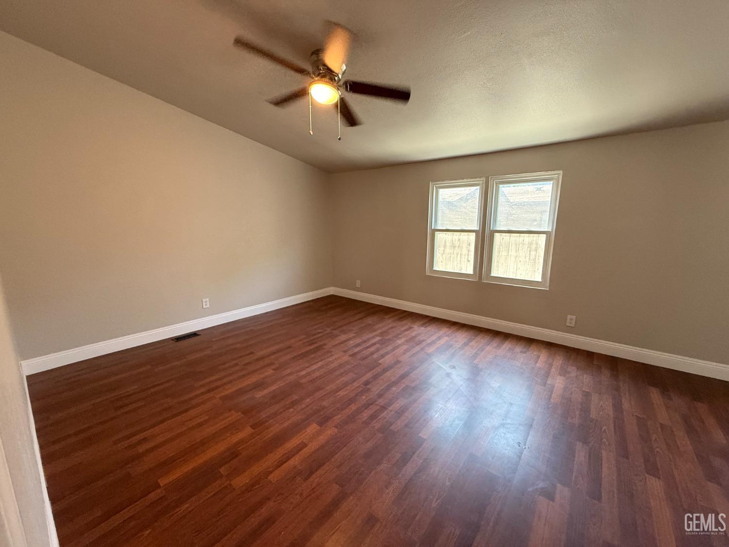Undisclosed Address Bakersfield, CA 93307 - Photo 20 of 27 wooden floor in an empty room with a window