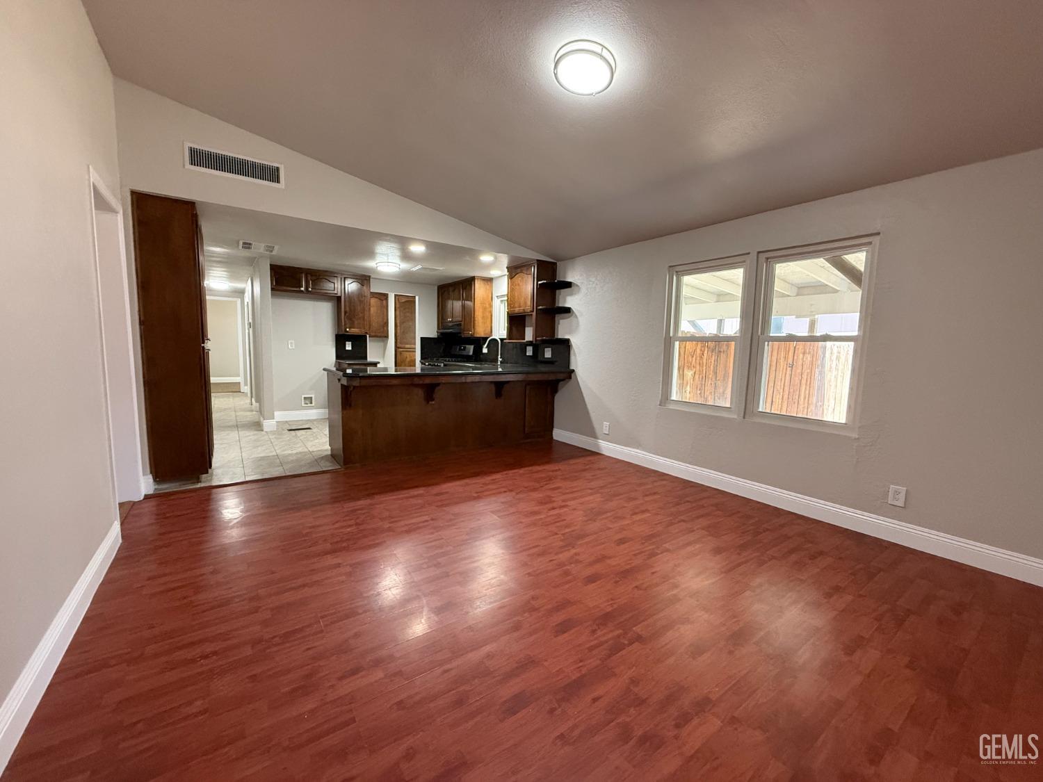 Undisclosed Address Bakersfield, CA 93307 - Photo 7 of 27 a view of a kitchen with refrigerator microwave and windows